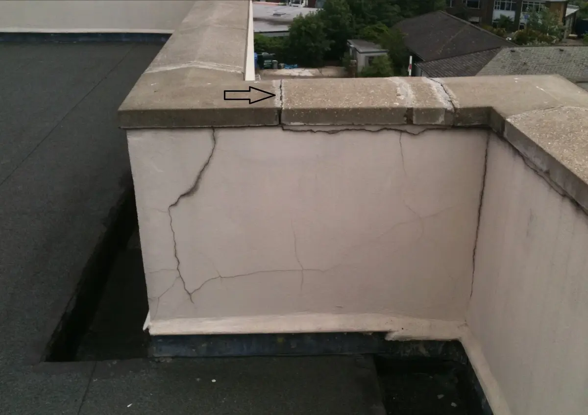 cracked stucco parapet on a flat-roof home